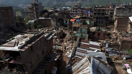 Local residents walk past collapsed houses after the April 25 earthquake in Sankhu on the outskirts of Kathmandu, Nepal, May 11, 2015. REUTERS/Athit Perawongmetha  - RTX1CFNY