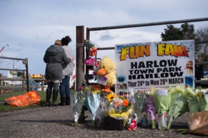 Floral tributes at the scene where a seven-year-old girl died after she was blown around 150 metres on a bouncy castle, which is thought to have been swept away by a sudden gust of wind at an Easter fair. PRESS ASSOCIATION Photo. Picture date: Sunday March 27, 2016. Families had gathered at Harlow Town Park in Essex on Saturday for the third day of the event organised by Thurston fun fairs over the holiday weekend. See PA story POLICE Girl. Photo credit should read: Stefan Rousseau/PA Wire