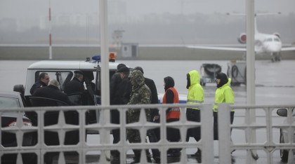 Russian Emergency Situations Ministry employees and police officers are seen as they take a car to drive to the area of a plane crash at the Rostov-on-Don airport, about 950 kilometers (600 miles) south of Moscow, Russia Saturday, March 19, 2016. An airliner with 61 people aboard coming from Dubai crashed early Saturday while landing in the southern Russian city of Rostov-on-Don, Russias Emergencies Ministry said. (AP Photo)