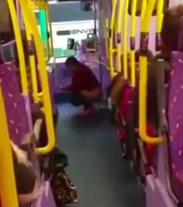 woman_appears_to_take_a_poo_on_middle_of_a_bus_12656900